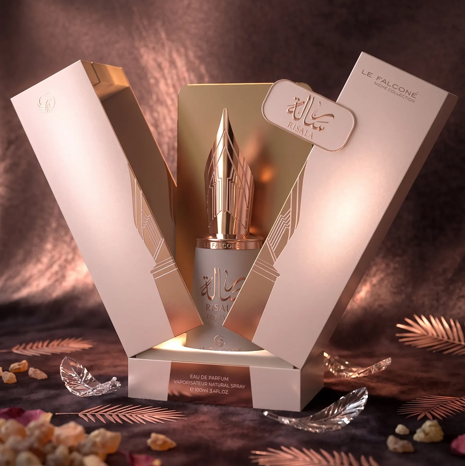 A luxurious product presentation of Risala Forever Eau de Parfum, featuring the 100ml bottle with its signature fountain-pen-nib cap, displayed inside its elegant gift box alongside decorative accents.